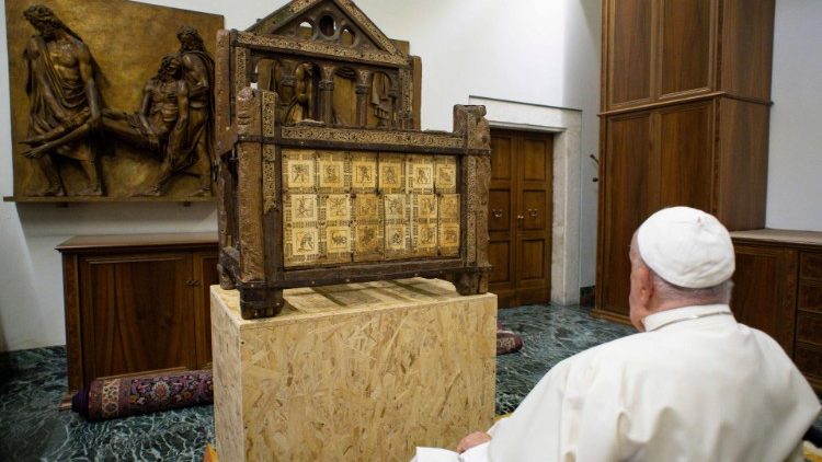 Pope Francis prays in front of a relic of the Chair of St. Peter.